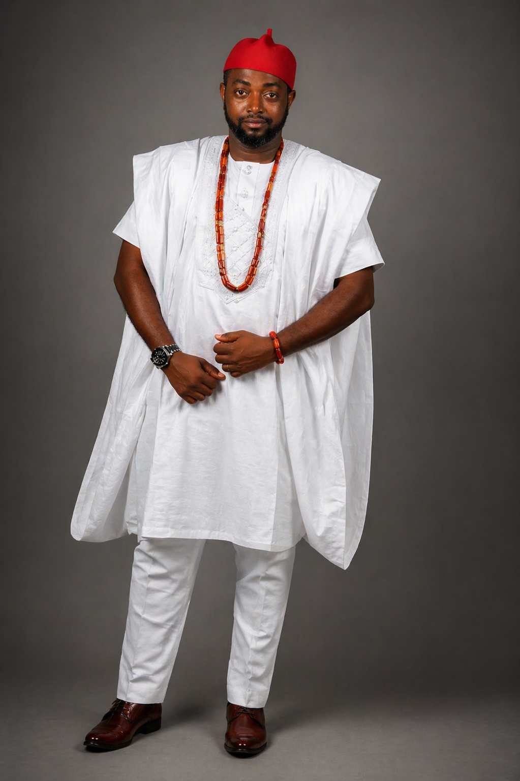 Chefiyke — white agbada, red traditional cap, coral beads